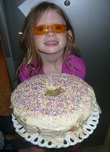 Here the cake is frosted and decorated with colorful sprinkles.